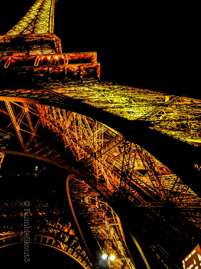 (Lava Glow) Eiffel Tower pillars glowing fiery Mars (RED) on the Champs de Mars, 7th arrondissement de Paris, at night. Arching Red Hot Metal Glowing on