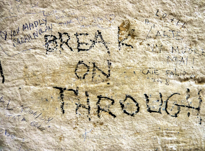 Graffiti iconic lyrics on a wall facing the Tomb of Jim Morrison, The Doors, at Cimetière du Père-Lachaise, 20th arrondissement of Paris. Break on Through Wall Paris