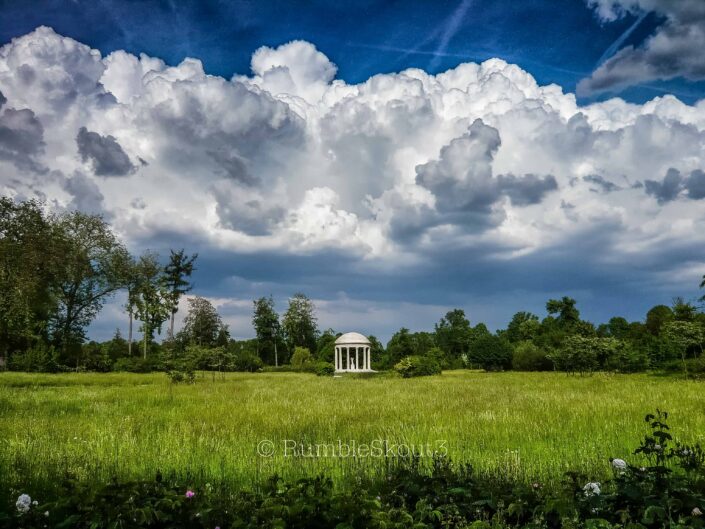 The estate of Trianon, Petit Trianon is where you will find the Grande Dame de Le Temple de l’Amour de Marie-Antoinette with grand cumulus thunderclouds in the distance. Marie-Antoinette's morning view of Cupid standing in the Temple of Love from her bedroom window at Petit Trianon, Château de Versailles. (folly) historic french architecture) Château de Versailles