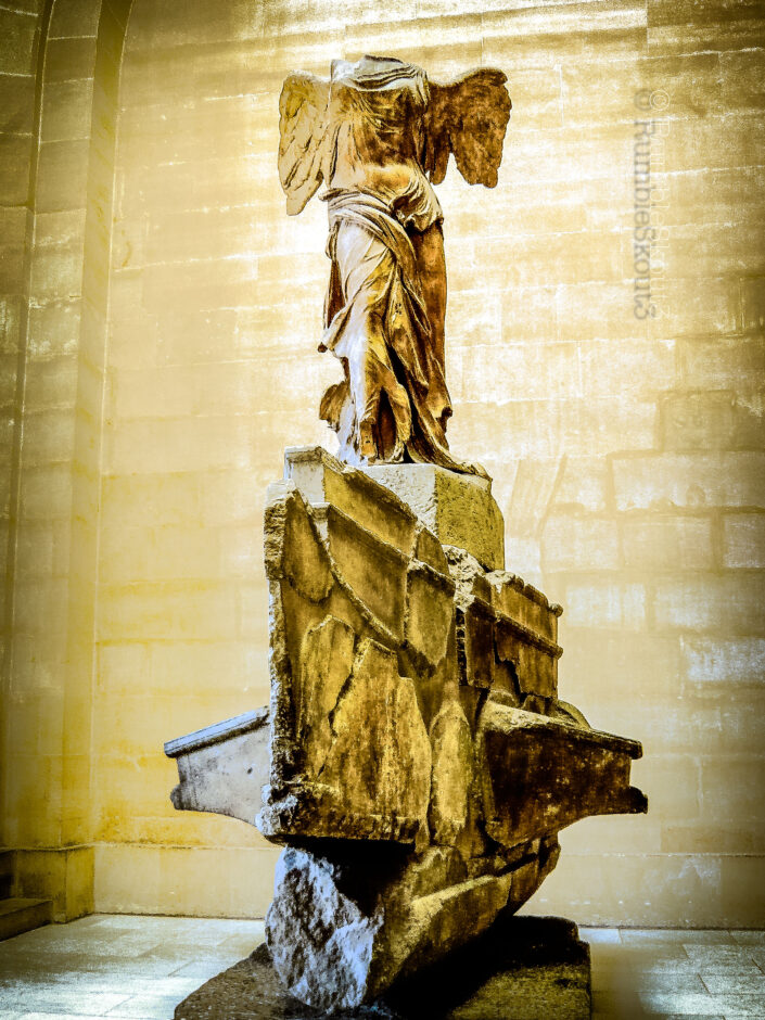 A stone woman sculpture, the Winged Victory of Samothrace Daru Staircase greets you at a wing of the Louvre Museum. Nike Alas de Roche 1st arrondissement of Paris