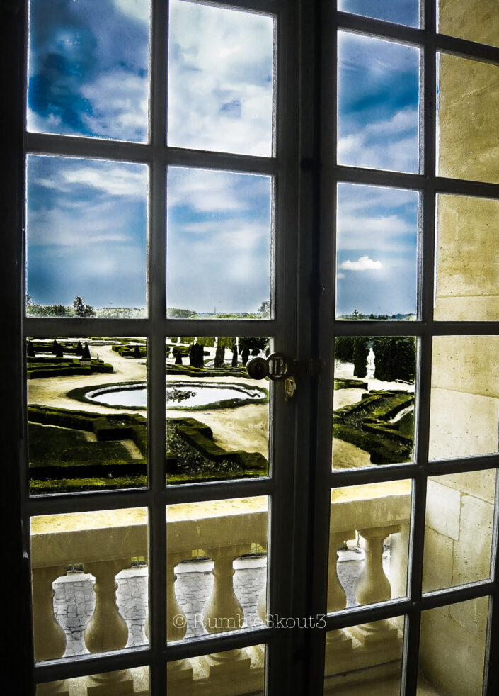 A wavy look through historic glass windows of Louis XIV French Doors, Jules Hardouin-Mansart and Louis Le Vau set the gold standard of French baroque architecture. The Sun King