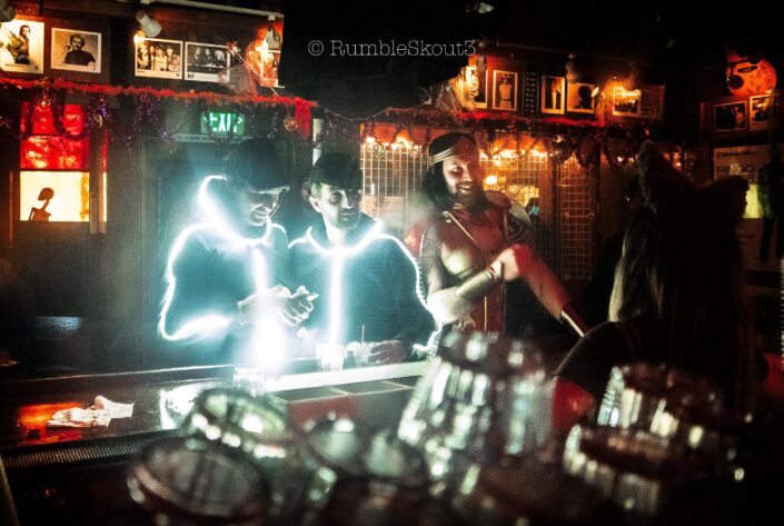 Walking into the front bar @ the Troubadour in West Hollywood are 2 Glowing Stick Men & Wonder Woman during Halloween Carnaval.