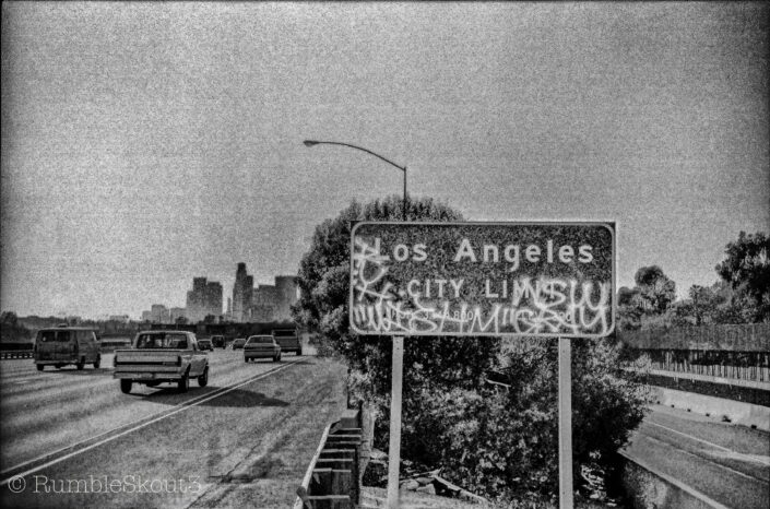 A black & white 35mm images of the City of Los Angeles city limit road sign, amplifying Los Angeles Street Photography. El Pueblo de la Reyna de Los Angeles Proper La Ciudad de Los Angeles