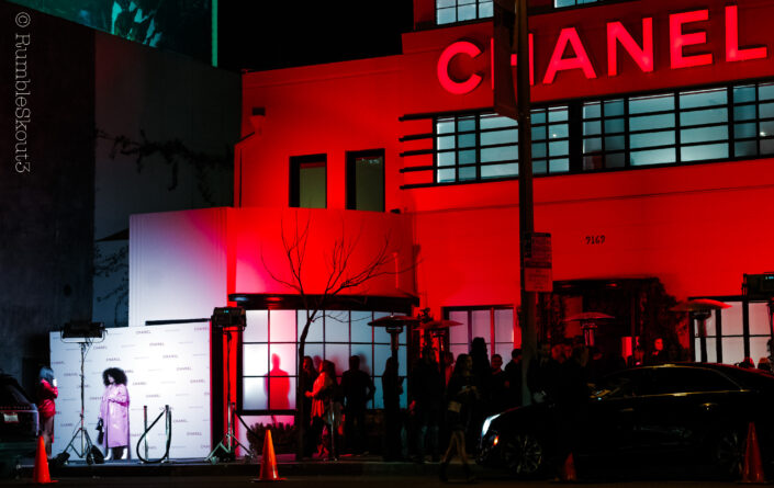 A girl in a pink leather trench coat at a Red Chanel Pop Up on the Sunset Strip at night on Sunset Blvd, West Hollywood, California. (Los Angeles Street Photography)