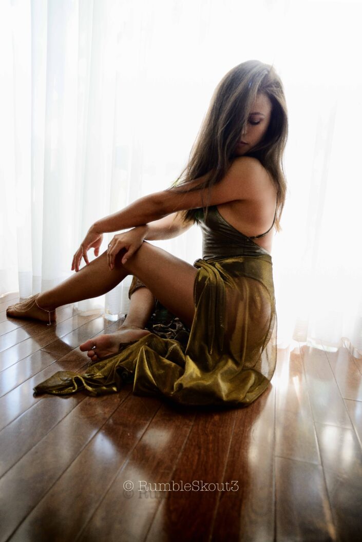 Sitting Pretty on Flores St. XI, an Ultra American Élégance model, in a bodysuit sheer dress, sitting in a natural light fashion photography session, California.