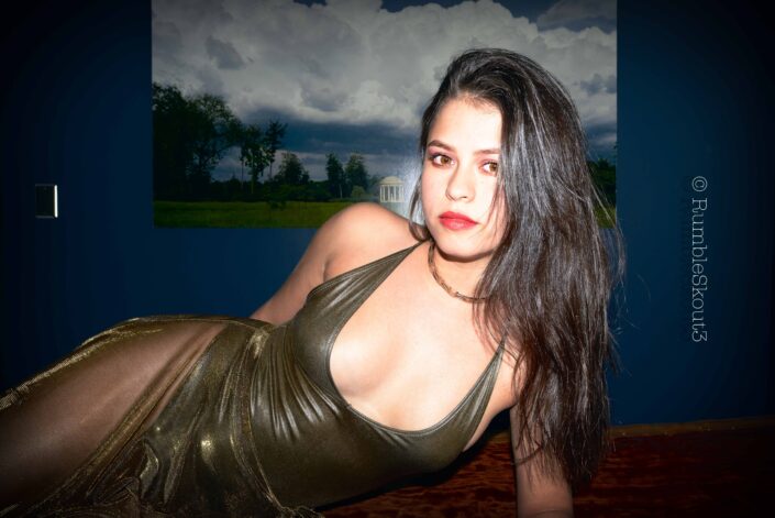 An American woman portrait of a Tigresa Fille, Liquid Rosewood III, on a Bubinga Solid Wood Slab, with amber eyes, in a bodysuit sheer dress in West Hollywood.